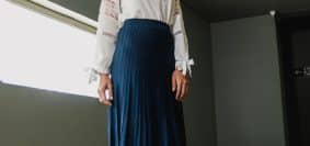 Woman Wearing White Long-sleeved Shirt and Blue Skirt